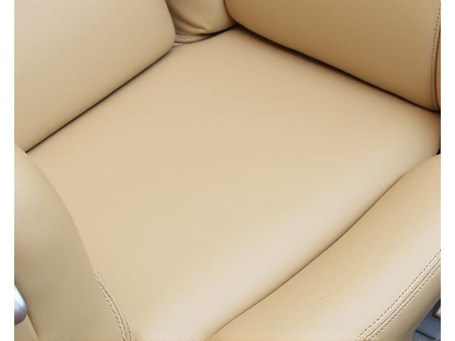 Restored beige leather car seat, looking new and supple
